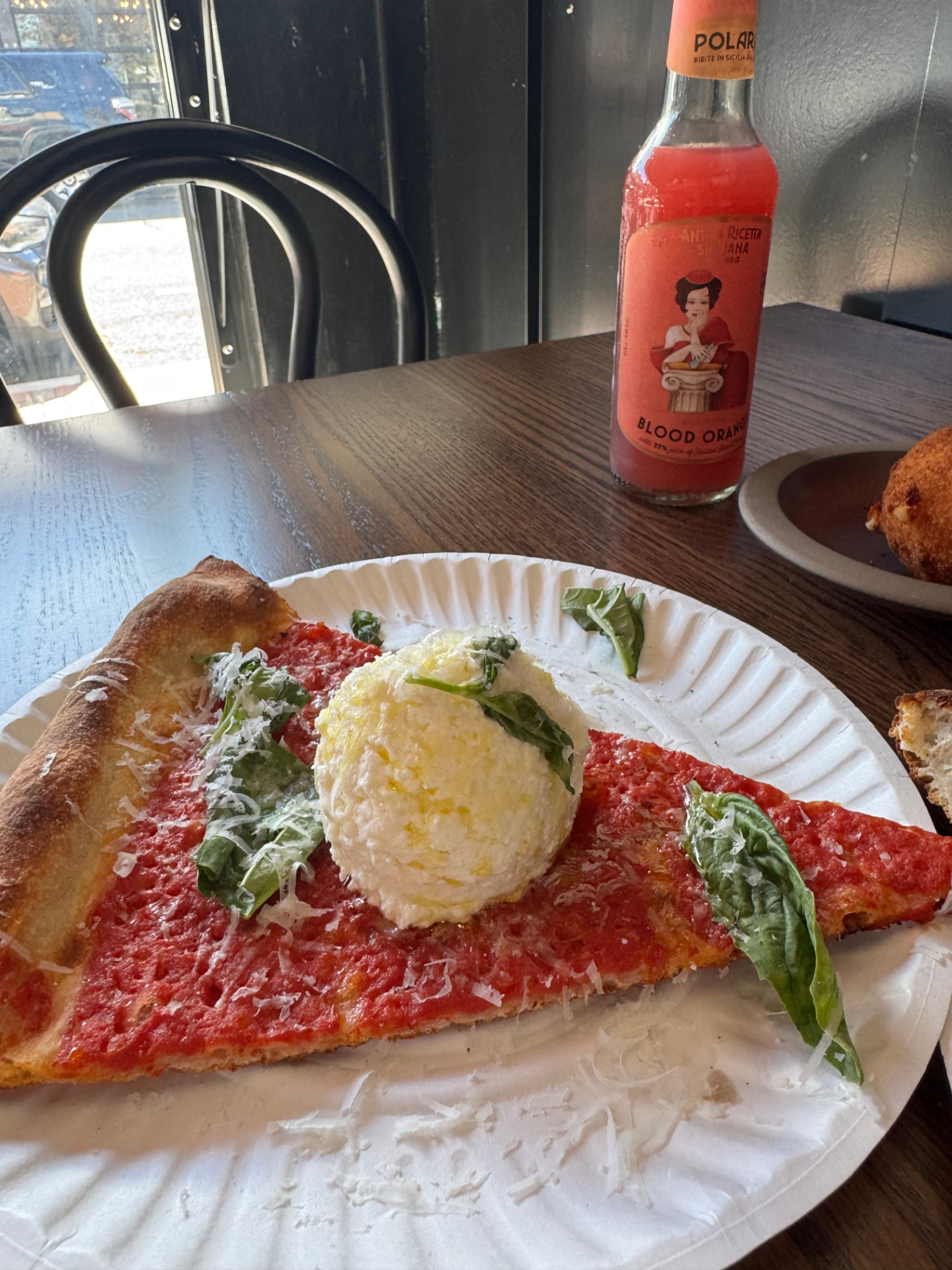 Jennifer’s ricotta tomato slice at Pollara, topped with ricotta and basil