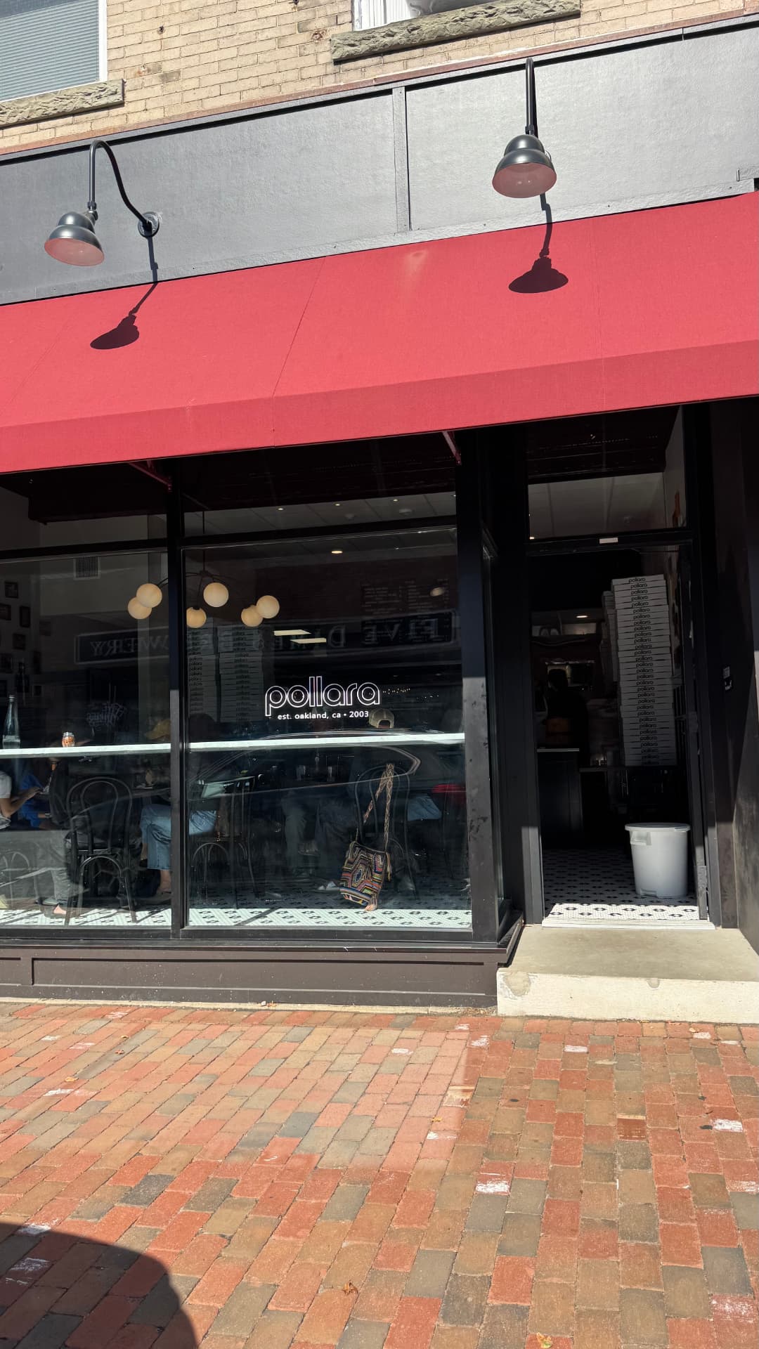 Pollara Pizzeria’s red awning and glass storefront on Monmouth Street in Red Bank