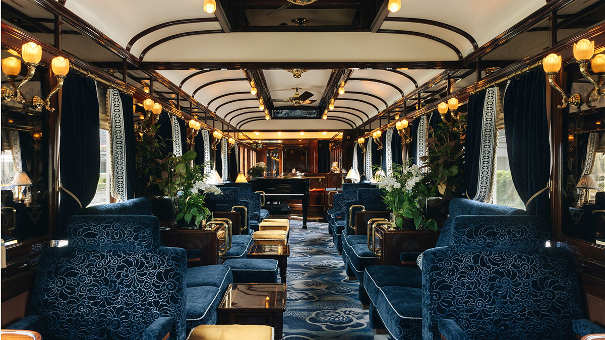 Blue upholstered seating and Art Deco interior in Bar Car 3674 aboard the Venice Simplon-Orient-Express