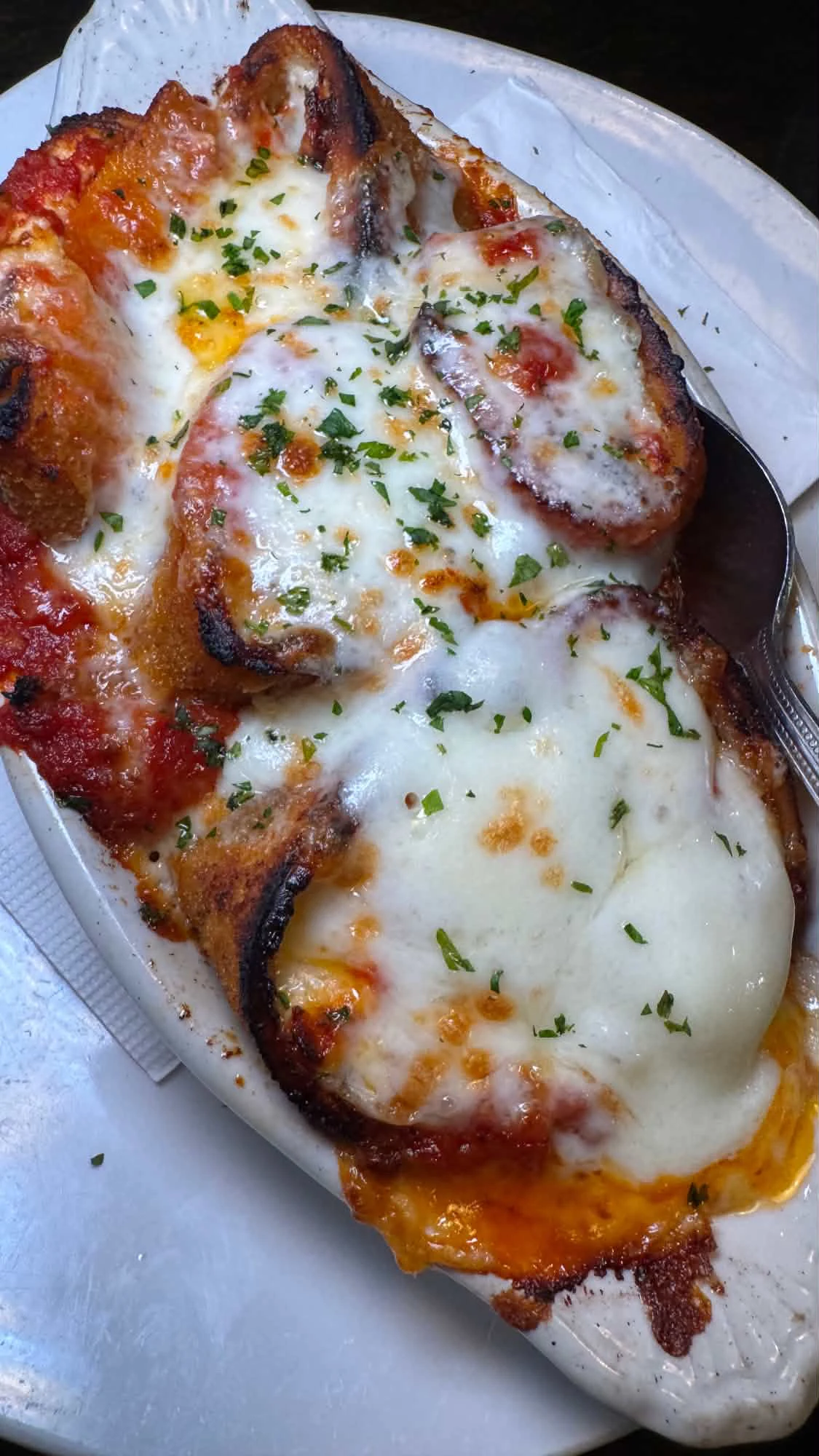 A hot baked Italian dish covered with melted cheese and herbs at Zoni’s in Sea Girt
