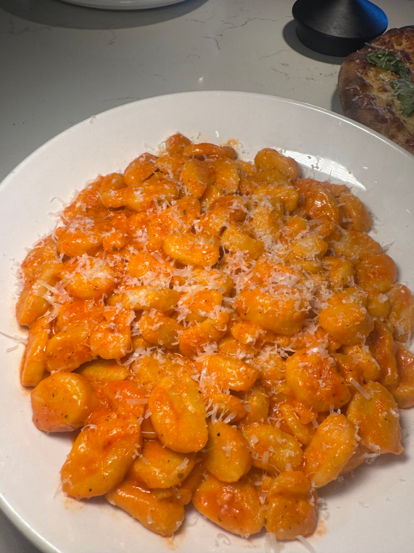 House-made ricotta gnocchi in a creamy sauce, topped with grated cheese